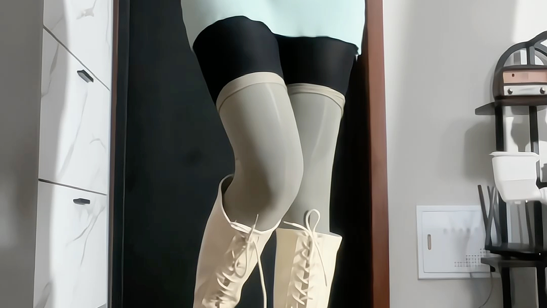Boots with hip-hugging skirt overlay