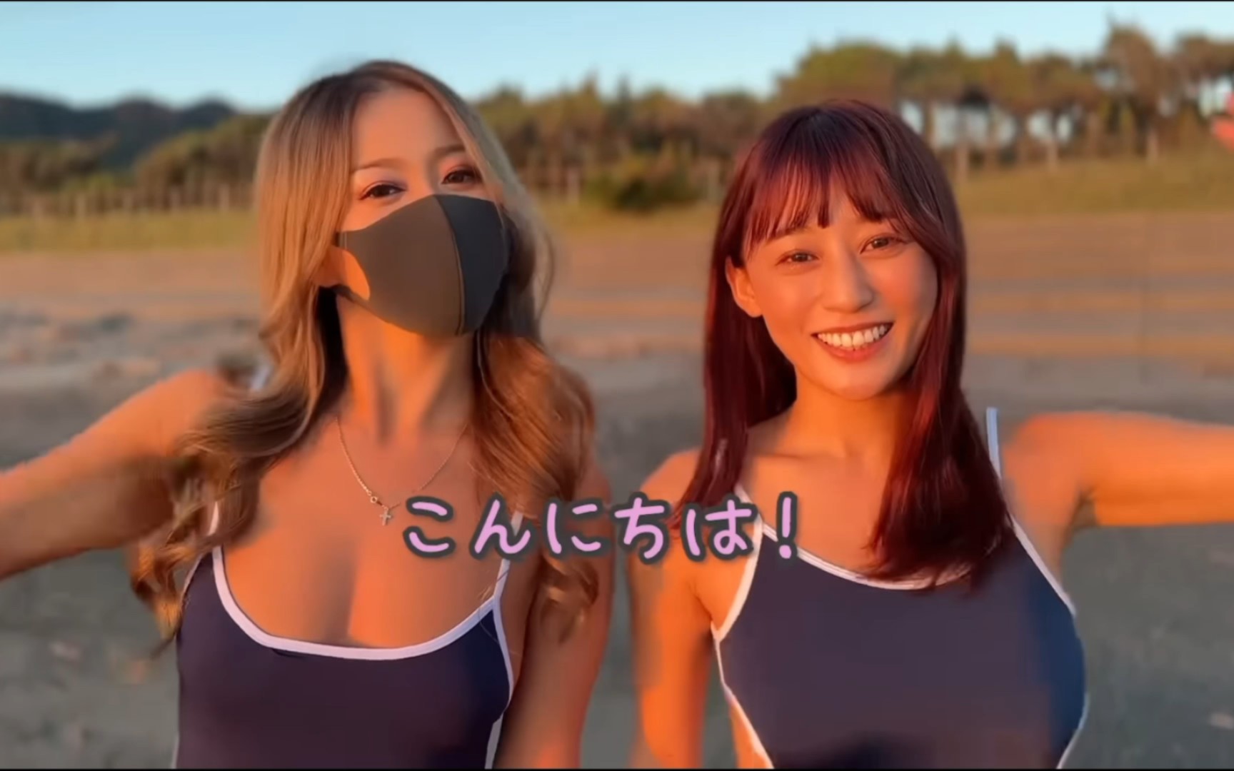 Two ladies in swimsuits playing games on the beach