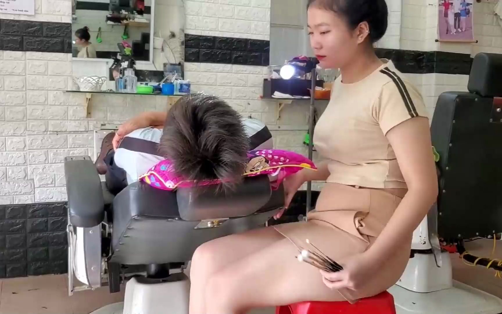 越南街边的理发店不仅老板娘亲自剪发,还有三个助手服务