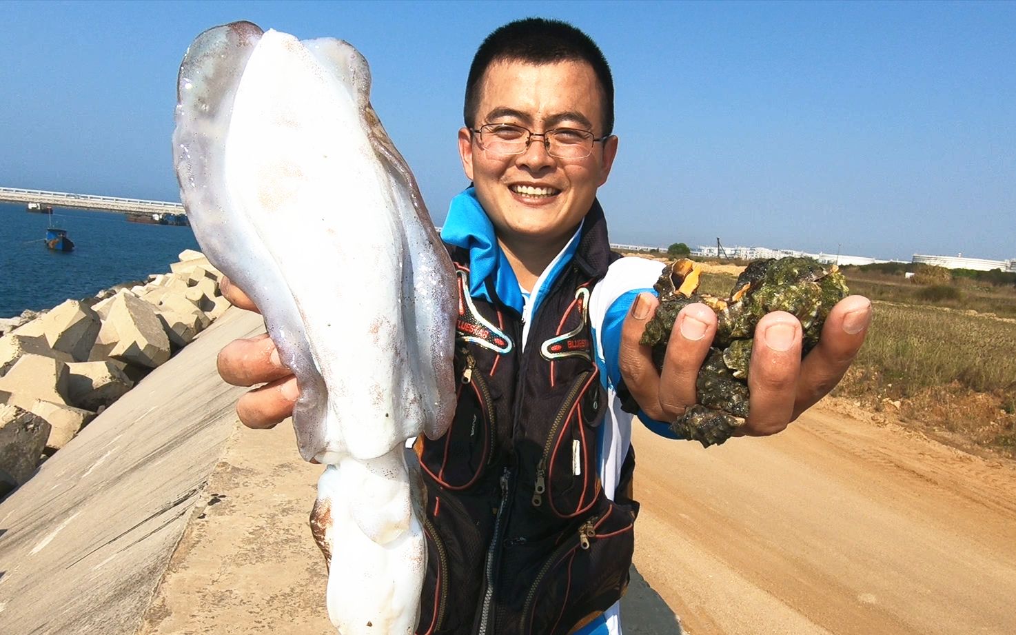 小伙赶海捡海螺,不料抓到条大墨鱼,这得有好几斤了