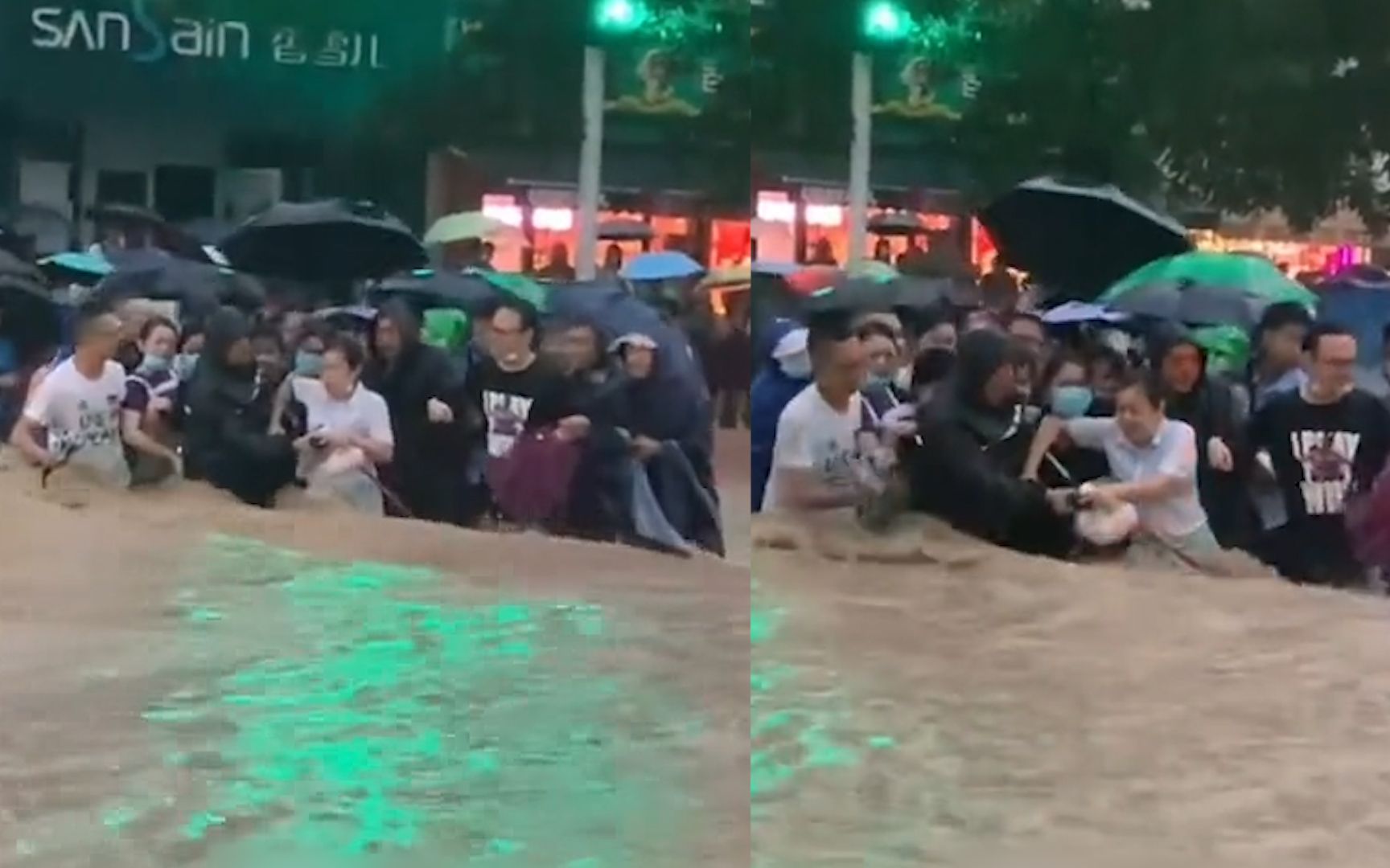 [图]郑州暴雨积水没过腰，市民扎堆抱团挽手组人墙，喊着口号过马路!